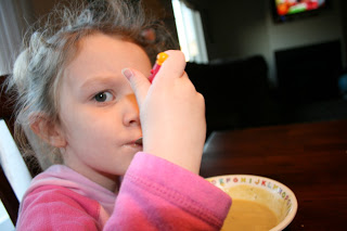 A young child eating the acorn squash soup