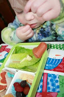 small child eating valentines day bento lucnh