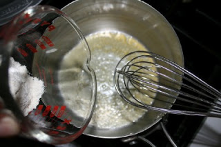 Whisking butter and added flour to cooking pot