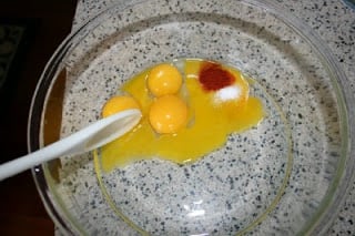 3 eggs, paprika and salt in a large glass mixing bowl