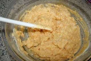 stirring together cheese sauce, rice, eggs and seasoning