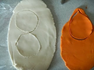 top down picture of circle shapes cut out of white and orange fondant