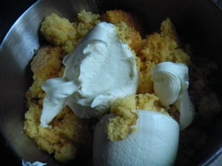 cooked, crumbled cake, frosting in a mixing bowl