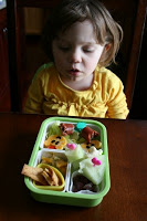 child sitting at a table looking at Tulip Bento