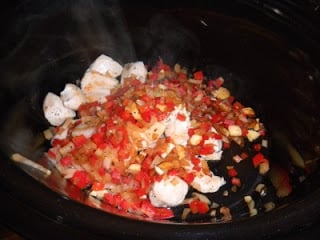 cooked chicken and sauted vegetables in a slow cooker