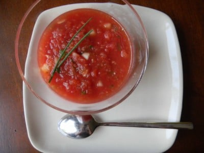 Tomato Watermelon Gazpacho served in a small glass bowl, with a spoon on the side
