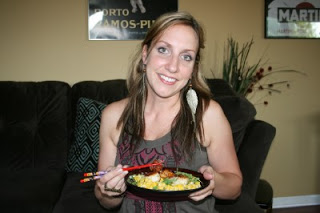 woman holding a plate of Creamed Corn and Scallops and chopsticks