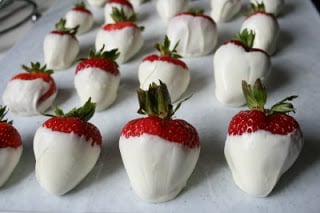 plain white chocolate covered strawberries set on parchment paper