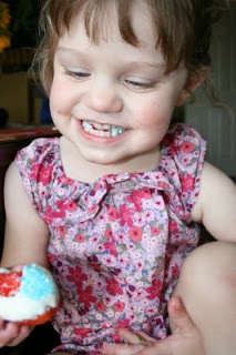 girl holding a Red, White & Blue Chocolate Covered Strawberry, smiling