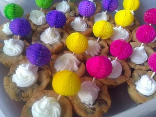 Chocolate Chip Cookie Cups with Almond Buttercream Frosting with colorful food picks inserted into center