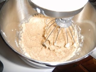 Mix together butter and sugars with electric mixer.