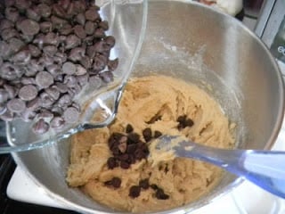 pouring chocolate chips into mixing bowl
