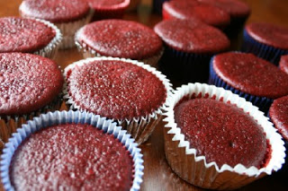 unfrosted red velvet cupcakes sitting on a table