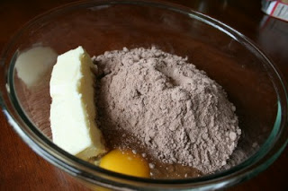 stick of butter, egg and cake mix in a large glass mixing bowl