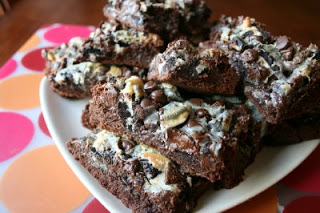 brownies stacked on a plate siting on a table