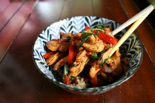 Thai Garlic & Basil Chicken served in a bowl with chopsticks