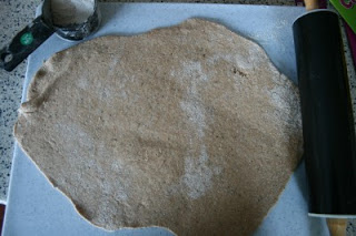 whole wheat dough rolled out on a cutting board