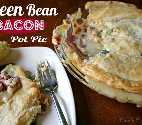 Cheesy Green Bean & Bacon Pot Pie , served on a white plate with a side of corn on the cob