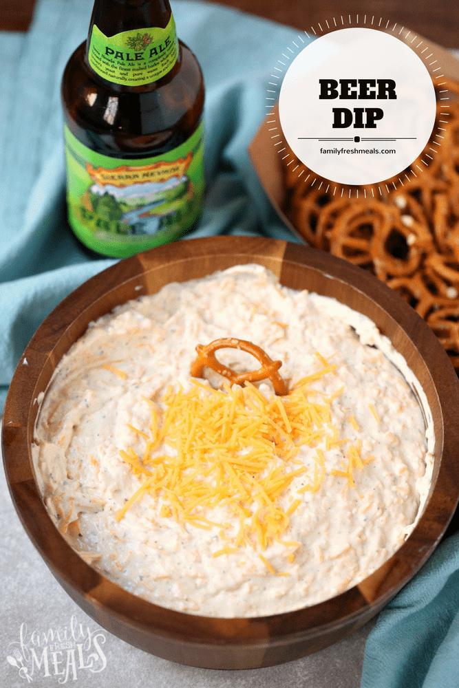 Beer Dip served in a bowl with pretzels and a bottle of beer 