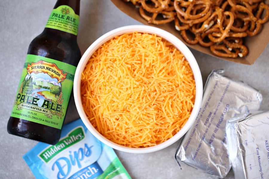 Beer Dip - Easy Party Dip Appetizer - Ingredients laid out. Shredded cheese, beer, cream cheese, pretzels and ranch dip