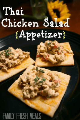 three  pieces of Thai Chicken Salad Appetizer on a black plate with sunflower in the background