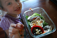 little girl sitting a a table with Gruesome Grub Halloween Lunch