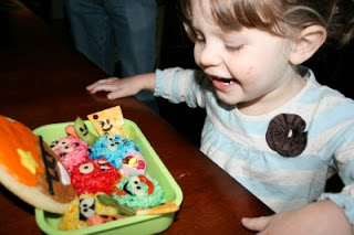 small child sitting at a table smiling at Yo Gaba Gaba - There's a Party In My Tummy Lunchbox