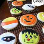 Halloween decorated sugar cookies on a cooling rack