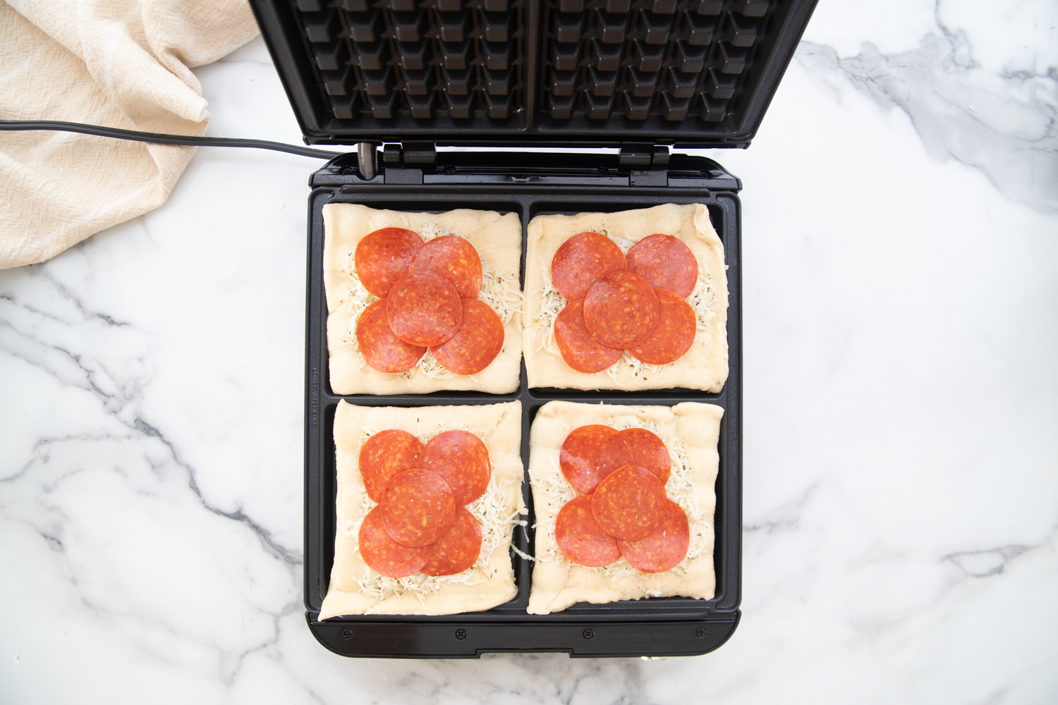 Add pepperoni slices to cheese top