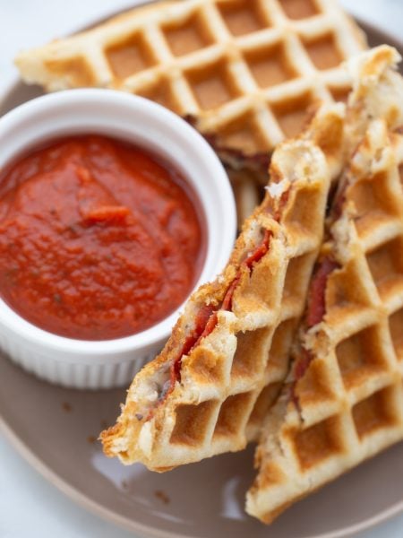 Waffle Pizza Dippers on a plate with sauce
