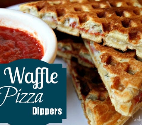4 pieces of Waffle Pizza Dippers stacked on a plate with a side of red sauce