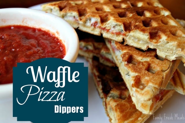 4 pieces of Waffle Pizza Dippers stacked on a plate with a side of red sauce