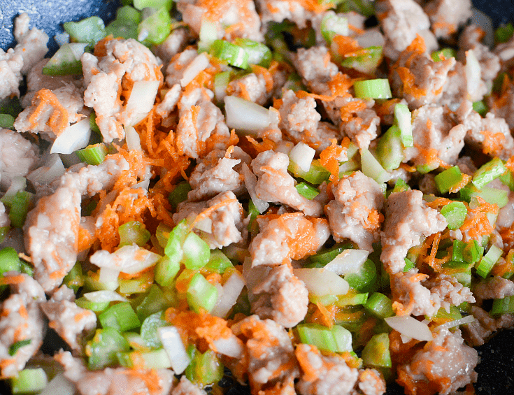 Ground turkey and chopped vegetables cooking in a pan