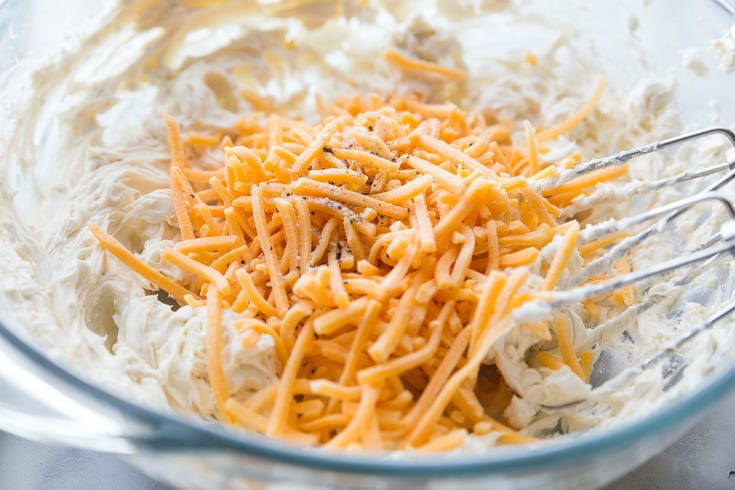 Mini Cheese Balls - Cream cheese seasoning and shredded cheese mixed in a glass bowl