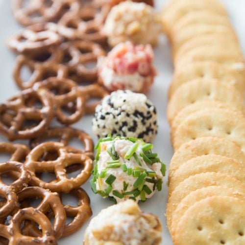 Mini Cheese Balls Recipe served on a white plate with crackers and pretzels