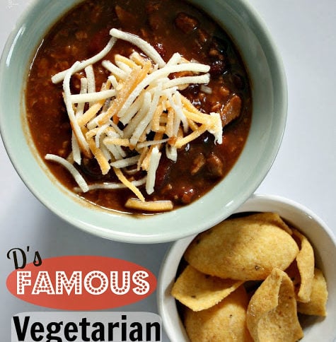 top down photo of Darryl's Famous Vegetarian Chili, topped with shredded cheese and a side of corn chips
