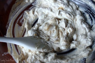 mixing creamy mixture in a large mixing bowl