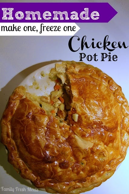 Chicken pot pie in a baking dish with 1 piece cut out of it