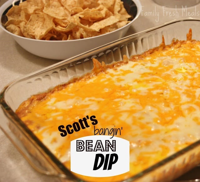 Cheesy Bean Dip in a baking dish with chips in a bowl