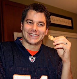 Man eating bean dip with tortilla chip