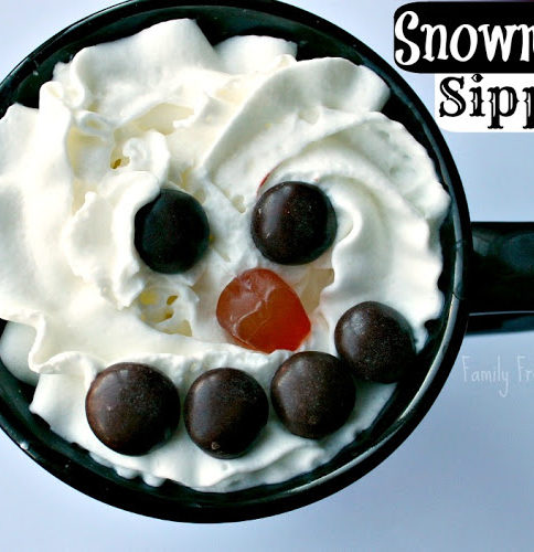 Top down image of Snowman Hot Chocolate Sipper - hot cocoa topped with whipped cream, m and m's and gummy