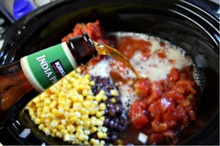 Crockpot Chicken Taco Soup - placing the rest of the soup ingredients into crockpot