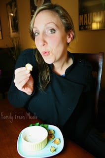 Woman holding a sliced pickle