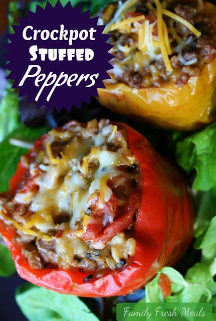 Two Crockpot Stuffed Bell Peppers served on a bed of lettuce