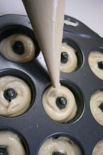 putting donut batter in mini donut baking pan