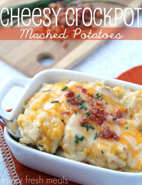 cheesy crockpot potatoes in a white serving dish