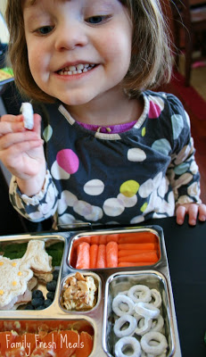 Child smiling at Spring themed lunchbox