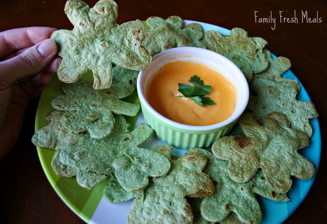 EASY Homemade Tortilla Chips served on a plate with cheese dipping sauce