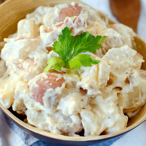 Creamy Ranch Crockpot Potatoes recipe served in a wooden bowl