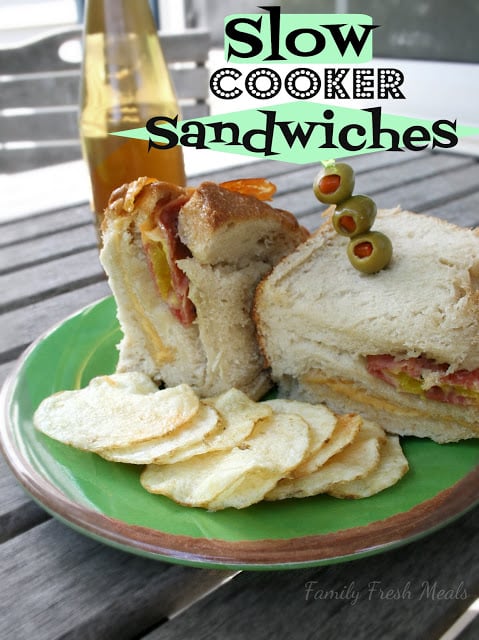 Slow Cooker Sandwiches served on a green plate with potato chips